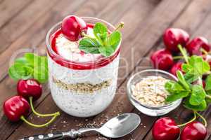 Fresh cherry yogurt with oats and chia seeds, delicious dessert for healthy breakfast