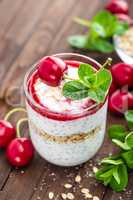 Fresh cherry yogurt with oats and chia seeds, delicious dessert for healthy breakfast