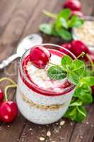 Fresh cherry yogurt with oats and chia seeds, delicious dessert for healthy breakfast