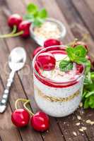 Fresh cherry yogurt with oats and chia seeds, delicious dessert for healthy breakfast