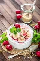 Fresh yogurt with cherry, banana and oats, delicious dessert for healthy breakfast