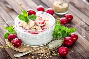 Fresh yogurt with cherry, banana and oats, delicious dessert for healthy breakfast