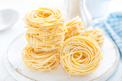 Raw pasta on white background closeup