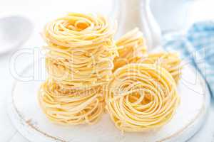 Raw pasta on white background closeup