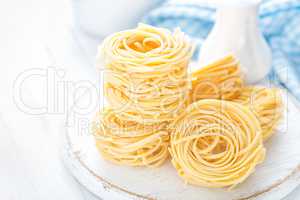 Raw pasta on white background closeup