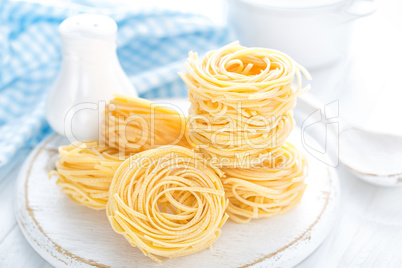 Raw pasta on white background closeup