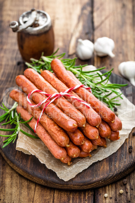 Sausages on wooden background