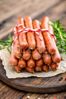 Sausages on wooden background