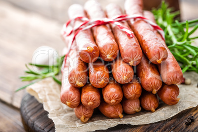 Sausages on wooden background