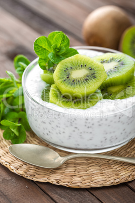 Fresh kiwi yogurt with fruits and chia seeds, healthy breakfast