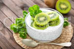 Fresh kiwi yogurt with fruits and chia seeds, healthy breakfast