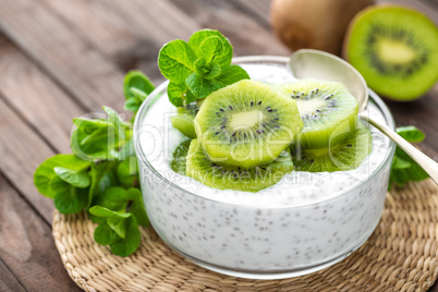 Fresh kiwi yogurt with fruits and chia seeds, healthy breakfast