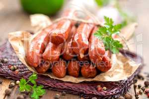 Sausages on wooden background