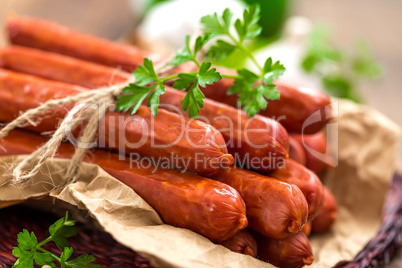 Sausages on wooden background