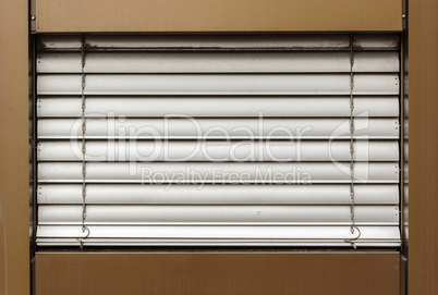 aluminum white blinds on the window