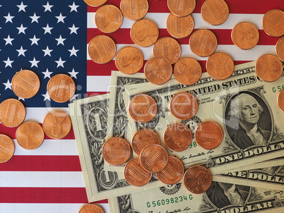 Dollar notes and coins and flag of the United States