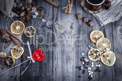 Red wooden heart on a gray surface with a coffee drink and sweet