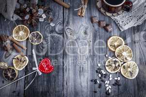 Red wooden heart on a gray surface with a coffee drink and sweet