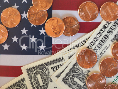 Dollar notes and coins and flag of the United States