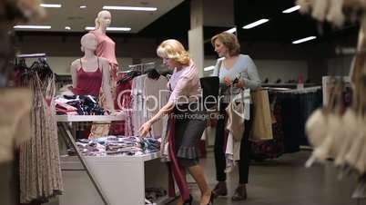 Beautiful women shopping for clothes at store