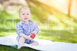 Mixed Race Infant Baby Boy Sitting on Blanket Holding Apple Outs