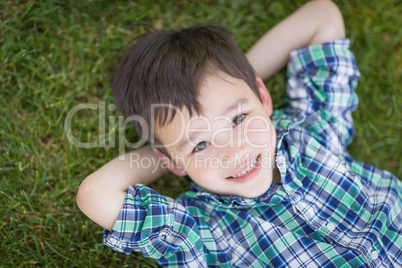 Mixed Race Chinese and Caucasian Young Boy Relaxing On His Back