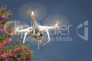 Unmanned Aircraft System (UAV) Quadcopter Drone In The Air.