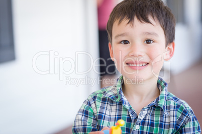 Portrait of Mixed Race Chinese and Caucasian Young Boy With Toy
