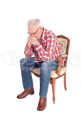 Senior man sitting and thinking.