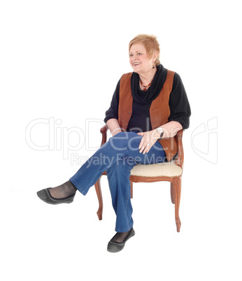 Senior woman relaxing, sitting.