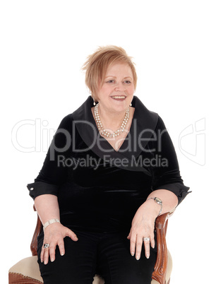 Senior woman relaxing in armchair.