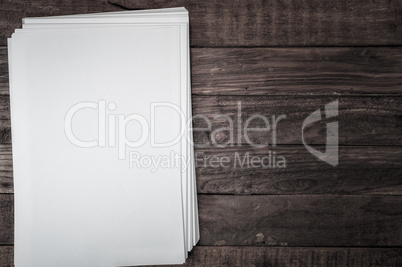 stack of sheets on white brown wooden surface