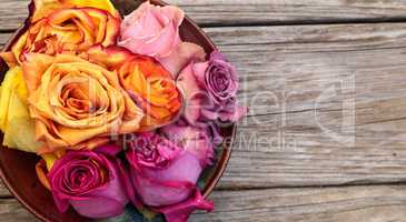 Rose petals in a bowl in the colors of a sunset
