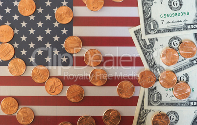 Dollar notes and coins and flag of the United States