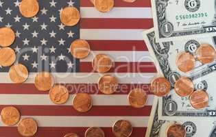 Dollar notes and coins and flag of the United States