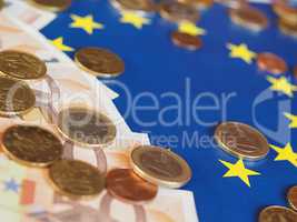 Euro notes and coins, European Union, over flag
