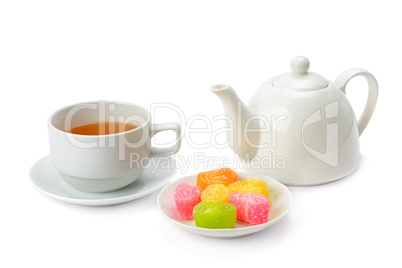 Teapot, tea in a cup and jujube isolated on white background.