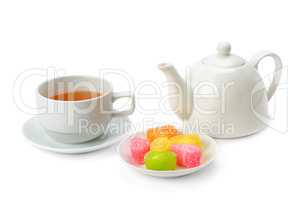 Teapot, tea in a cup and jujube isolated on white background.