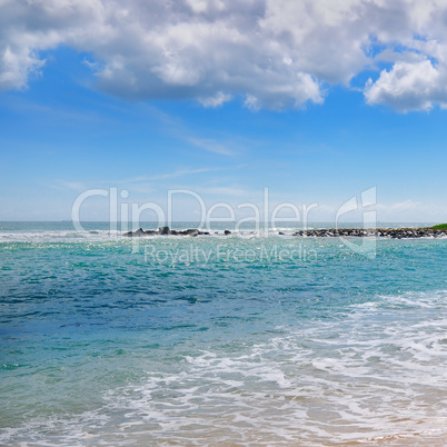 ocean, sandy beach and blue sky