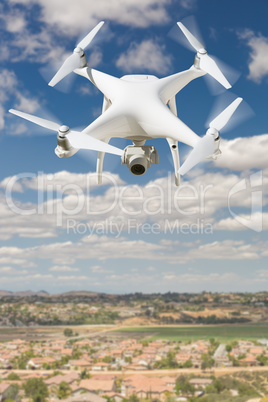 Unmanned Aircraft System (UAV) Quadcopter Drone In The Air Over