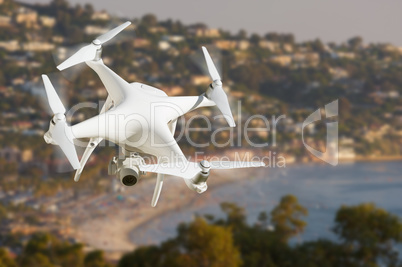 Unmanned Aircraft System (UAV) Quadcopter Drone In The Air Over