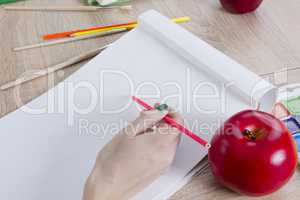 Artist is going to draw an apple