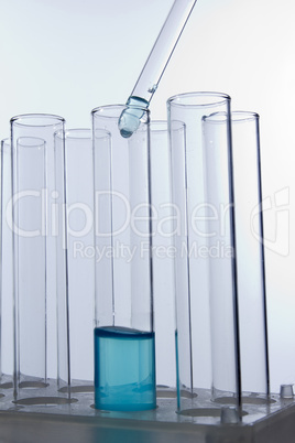 Dropper dropping liquid into test tube