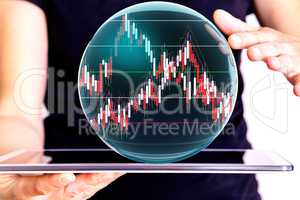 Hand holding tablet pc with glass globe and chart