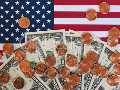 Dollar notes and coins and flag of the United States