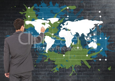 Businessman drawing  on Colorful Map with paint splatters on wall background