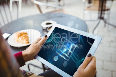 woman holding tablet with shopping cart on screen