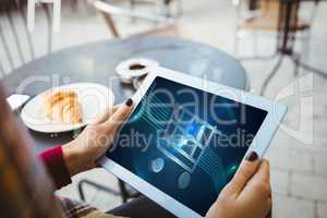 woman holding tablet with shopping cart on screen
