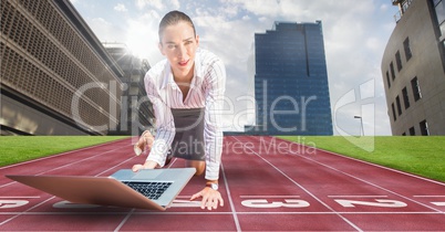 Composite image of business woman using laptop