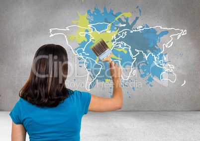 Woman painting a Colorful Map with paint splattered wall background